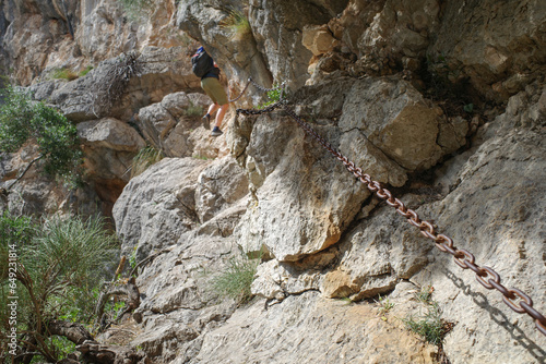 Mallorca, Spain - 12 June, 2023: Chain railings on a steep section of the GR221 hiking trail in the Tramontana Mountains, Mallorca photo