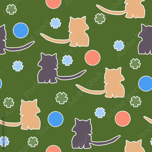 Seamless pattern of red, gray cats, flowers and balls on a green background for textiles.