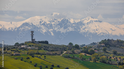 View from a hill in the city of Pineto, Italy, to the Apennine Mountains. picturesque Italian hills and snowy mountains on the horizon.