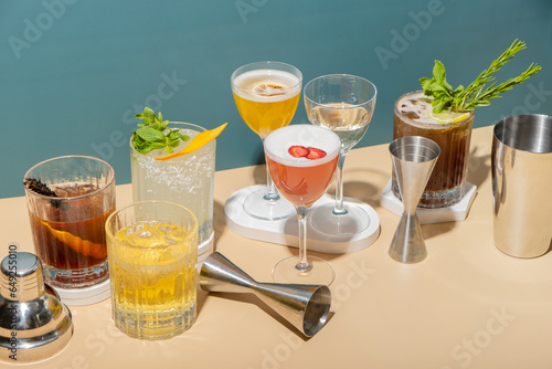 Принти на полотні Bar tools and alcoholic cocktails on podiums on colored background