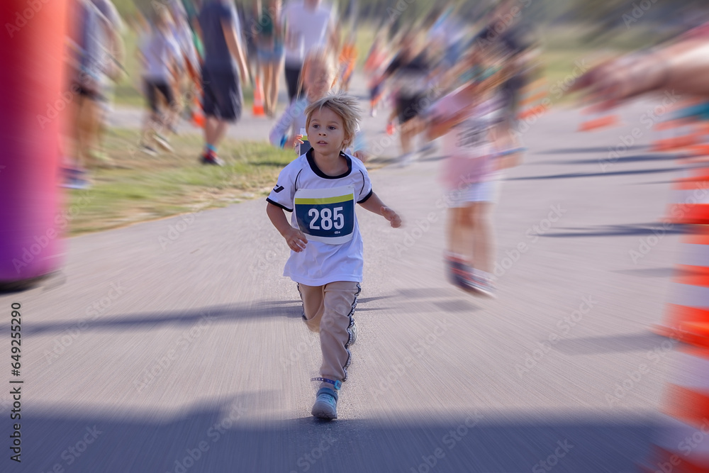 Young preschool children, running on track in a marathon competition.
