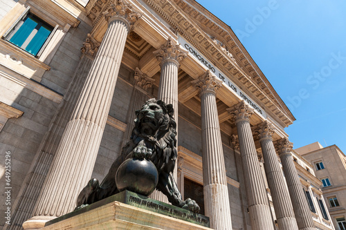 Madrid, Spain - May 13, 2011: Lion statue outside the Palace of the Parliament building or Palacio de las Cortes where the Congress of Deputies meets
