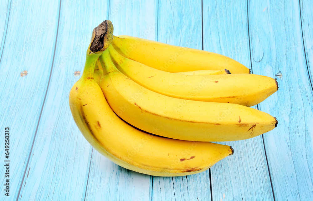 Ripe bananas on a blue wooden background Ripe bananas on a blue wooden background
