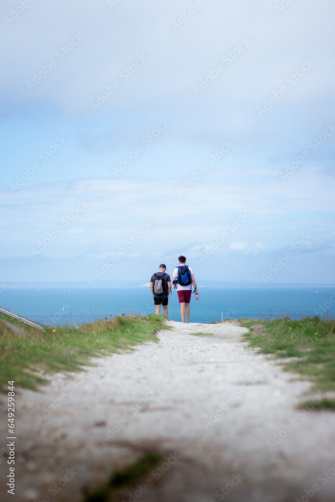 Two men on a hiking trip by the coast
