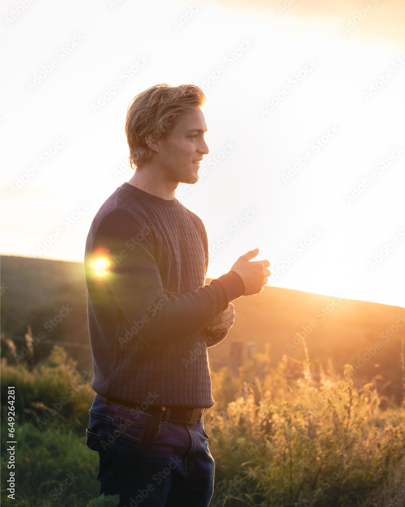 A man in a field at sunset A man in a field at sunset