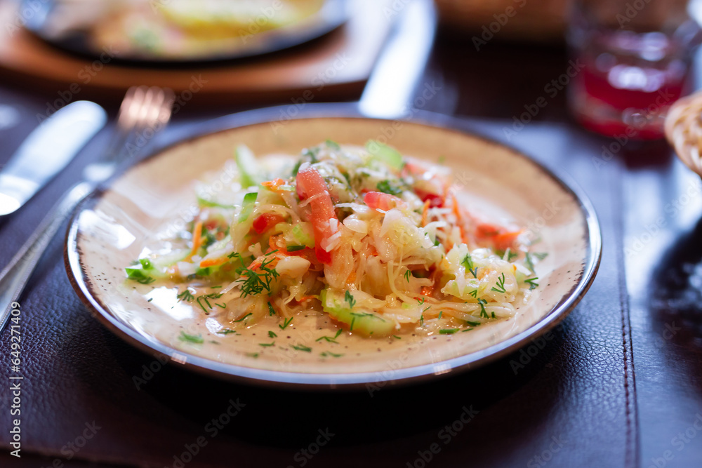 Fresh vegetable salad with tomatoes, cucumbers and celery on plate