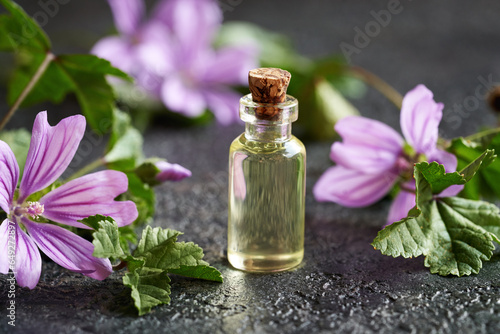 A bottle of common mallow essential oil on a table