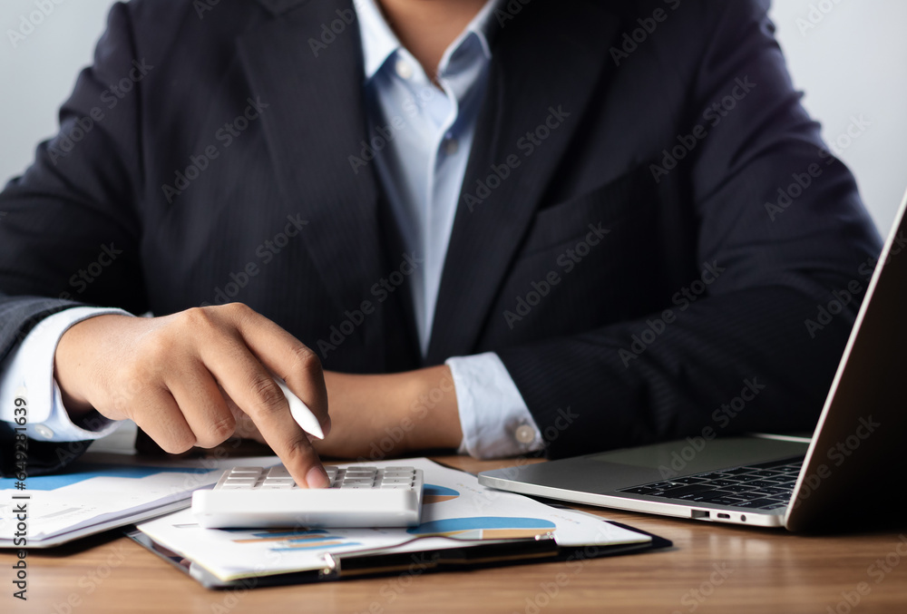 Businessman analyzing financial data for growth, read and write company performance reports, Financial analysis and planning and strategies to maximize sales profits.. Businessman analyzing financial data for growth, read and write company performance reports, Financial analysis and planning and strategies to maximize sales profits..