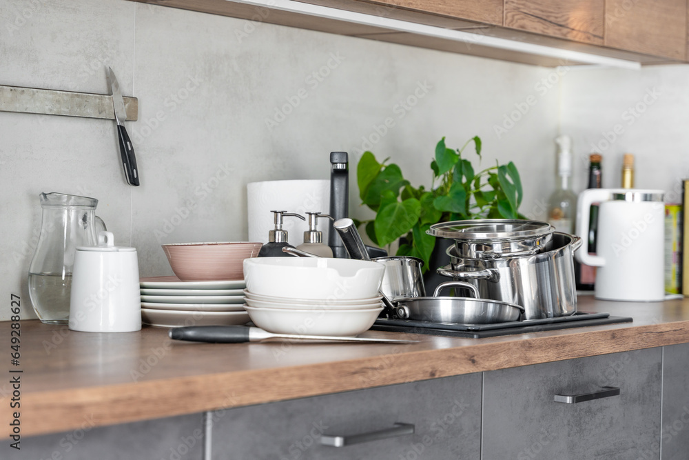 Dirty dishes and unwashed kitchen appliances filled the kitchen sink Dirty dishes and unwashed kitchen appliances filled the kitchen sink