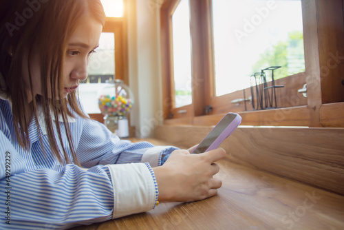 Businesswoman with hand using smart phone at coffee shop.