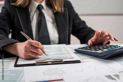 young woman work with tax form 2022. Deduction planning concept