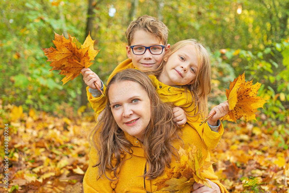 Happy family autumn leaves have fun in the yellow autumn park. Happy family autumn leaves have fun in the yellow autumn park.