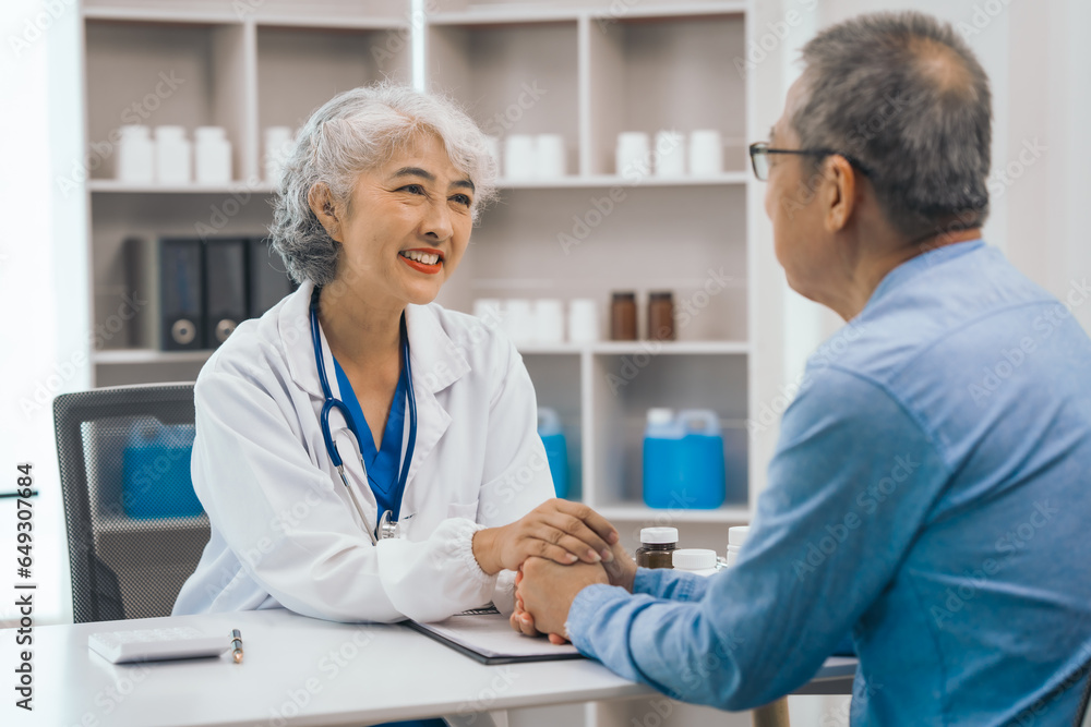Asian people mature dentist having a compassionate conversation with elderly patient, discussing oral health results, providing expert advice and detailed dental report. Dental Guidance Asian people mature dentist having a compassionate conversation with elderly patient, discussing oral health results, providing expert advice and detailed dental report. Dental Guidance