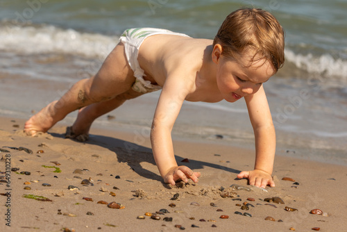 Junge spielt ausgelassen am Strand, Grenen bei Skagen, Dänemark photo