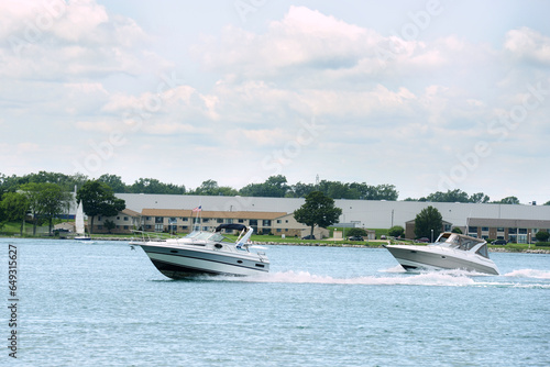 two cabin cruiser boats speeding on st clair river in ontario