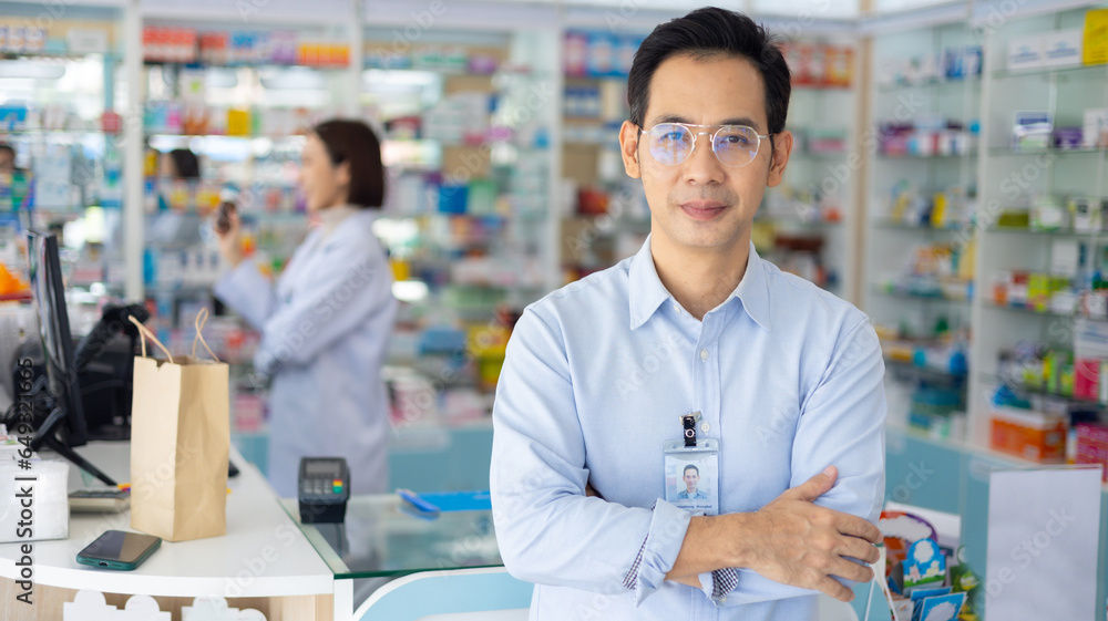 Pharmacy Drugstore. Portrait Professional Pharmacist handsome asian man showing the medicine bottle at pharma store. Health and wellness center