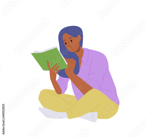 Concentrated smart young woman student reading book with interest enjoying indoor hobby activity