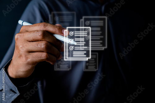 businessman utilizes an electronic pen to electronically mark checkboxes on a virtual document, facilitating paperless quality assurance and ERP management for the check and approve process.