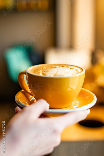 Woman hands holding cup of hot coffee latte cappuccino