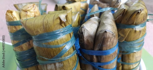 Buras or burasa is rice mixed with coconut milk wrapped in banana leaves and steamed. Delicious Bugis and Makassar people food, South Sulawesi, Indonesia photo