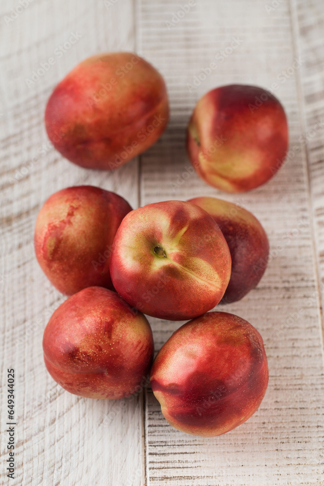 Juicy ripe nectarines on a white wooden background. Healthy eating, fruits. Juicy ripe nectarines on a white wooden background. Healthy eating, fruits.
