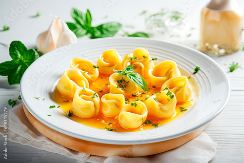 cappelletti in brodo. Traditional italian soup on wooden table photo