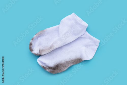 Dirty white socks on blue background.