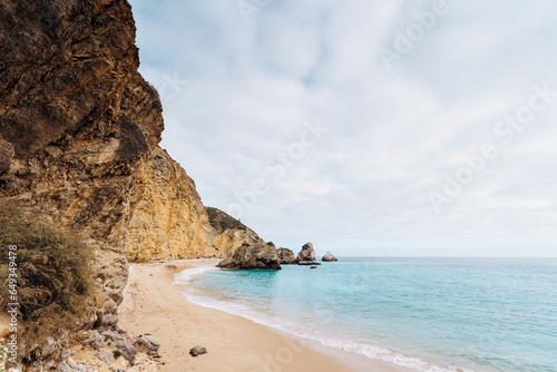 Secret beach in Sesimbra with high cliffs and sky blue water - Praia do Ribeiro do Cavalo