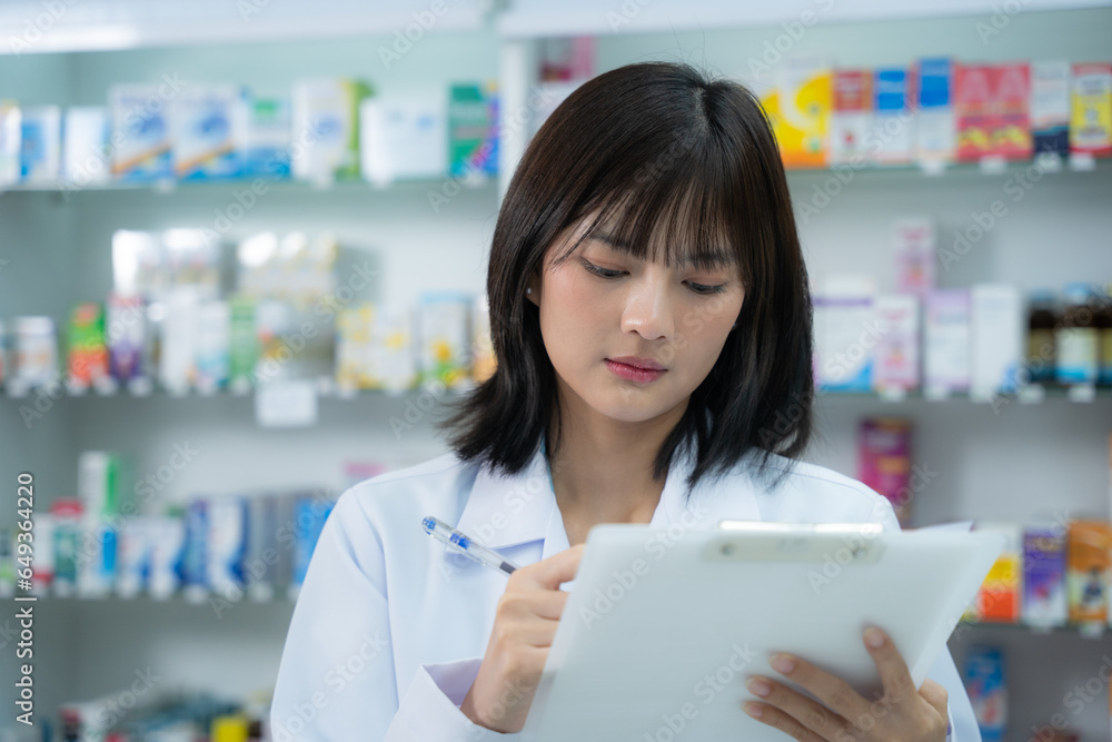 Young asian female pharmacist working at pharmacy store. Pharmacy, Medical, Healthcare, Lifestyle and Science concept.