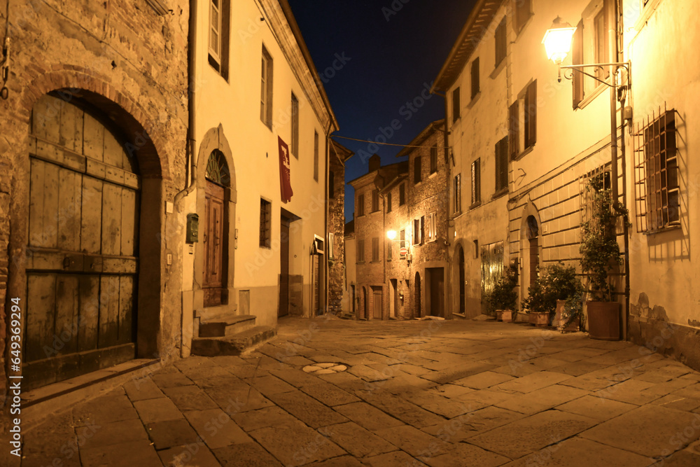 A street in the medieval neighborhood of Lucignano, a city in Tuscany, Italy.