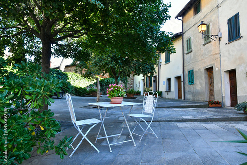 A table for relaxing on a street in the medieval neighborhood of Lucignano, a city in Tuscany, Italy. photo