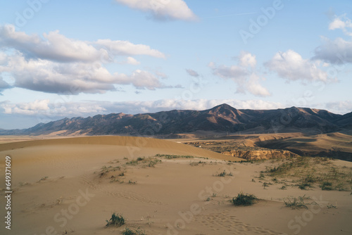 Desert valley with mountains and cloudy sky