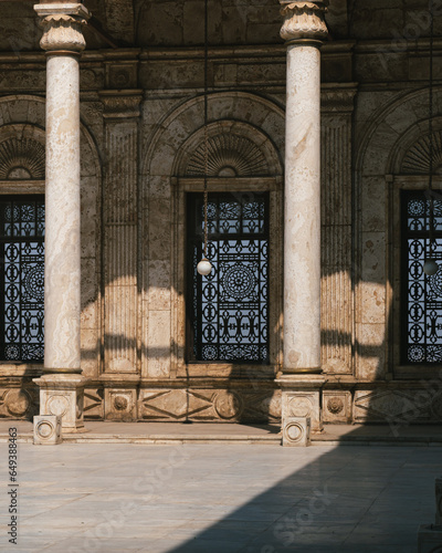 Interior of the courtyard of the Glass Mosque in the ancient city of Cairo, Egypt. Courtyard without people or tourists, with the porticos, windows, lamps and the fountain. Zooming shot.