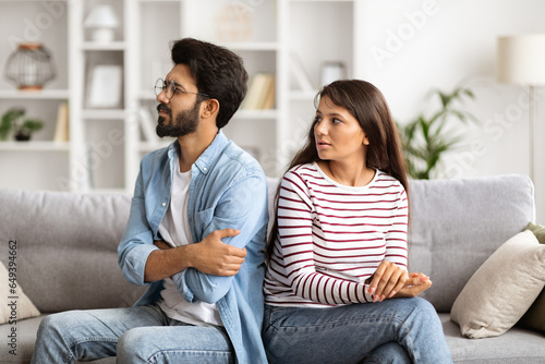 Stressed young indian woman looking at her offended husband