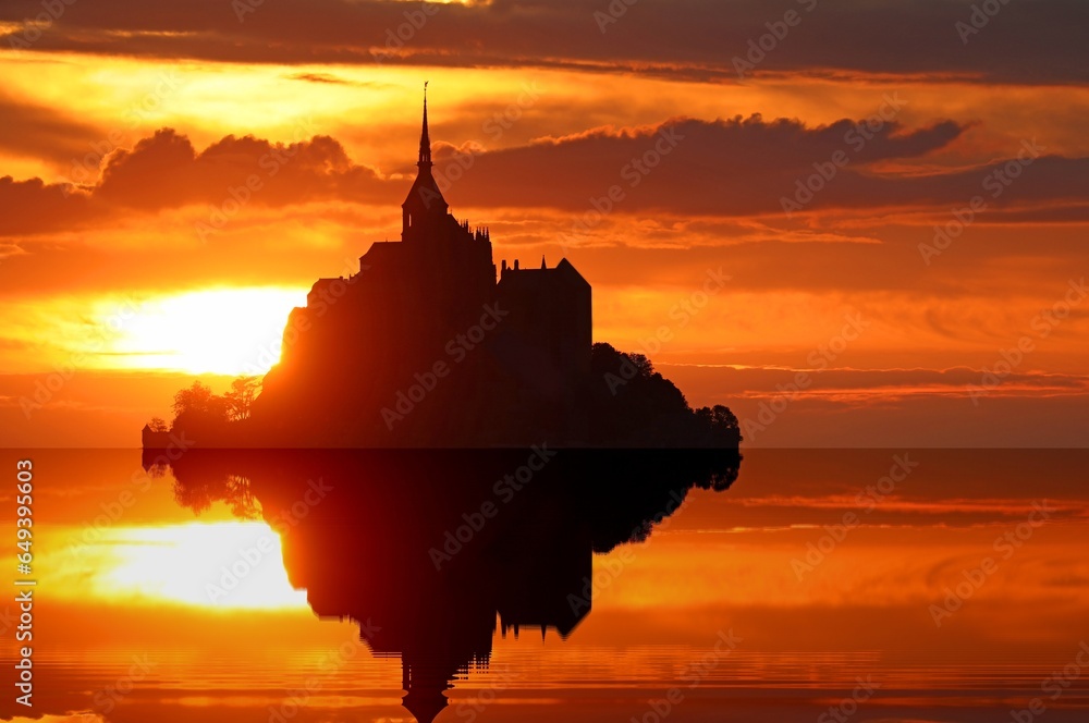Breathtaking romantic reflection at high tide with Abbey of Mont Saint Michel in France at sunset