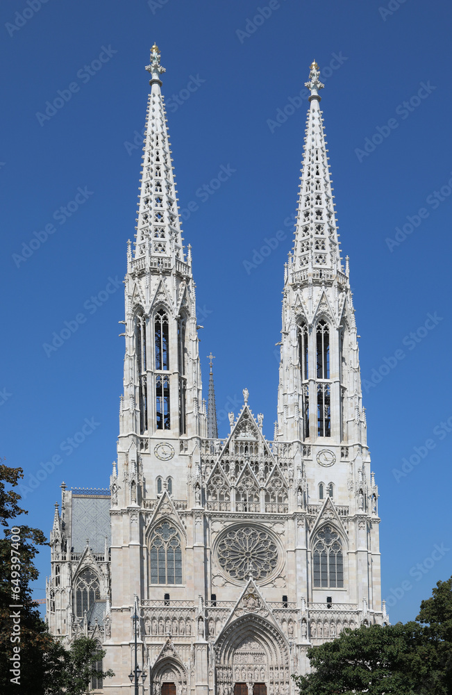 Two white bell towers of the VOTIVE CHURCH in Wien in Austria In Central Europe