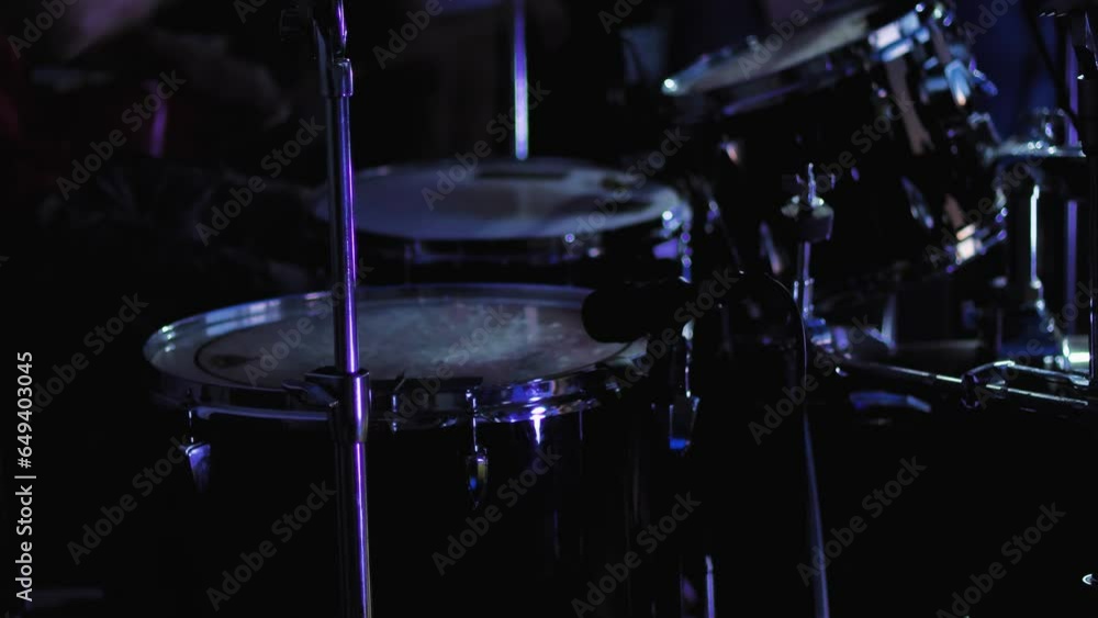 A professional drum kit close-up. Drummer playing drums in bright flashes of light. Selective focus. Concept of creativity and self-realisation A professional drum kit close-up. Drummer playing drums in bright flashes of light. Selective focus. Concept of creativity and self-realisation