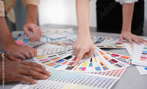 Professional Creative architect graphic desiner occupation choosing the Color pantone palette samples for project. Graphic designer working with pantone palette photo