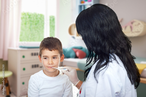 Doctor woman checking temperature to a child