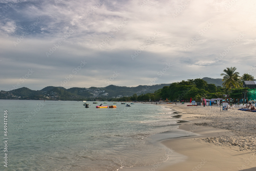 KOH SAMUI, THAILAND - SEPTEMBER 04,2023: Beautiful beach. View of nice tropical beach with white sand ,blue sea and blue sky. Holiday and vacation concept. Tropical beach Chaweng Noi beach, Samui.