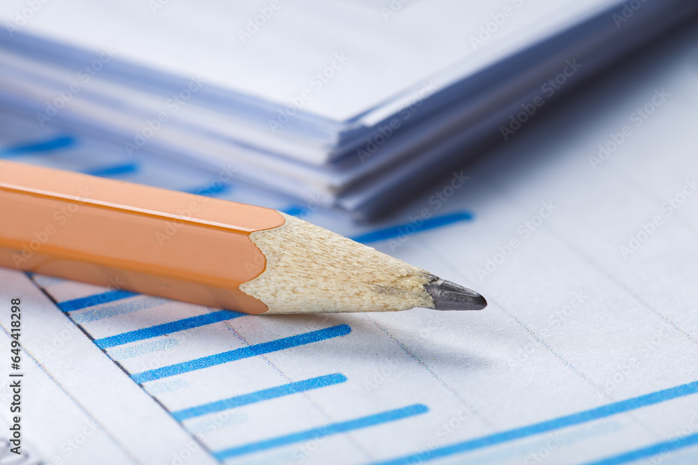 Accounting document with pencil and checking financial chart. Concept of banking, financial report and financial audit.