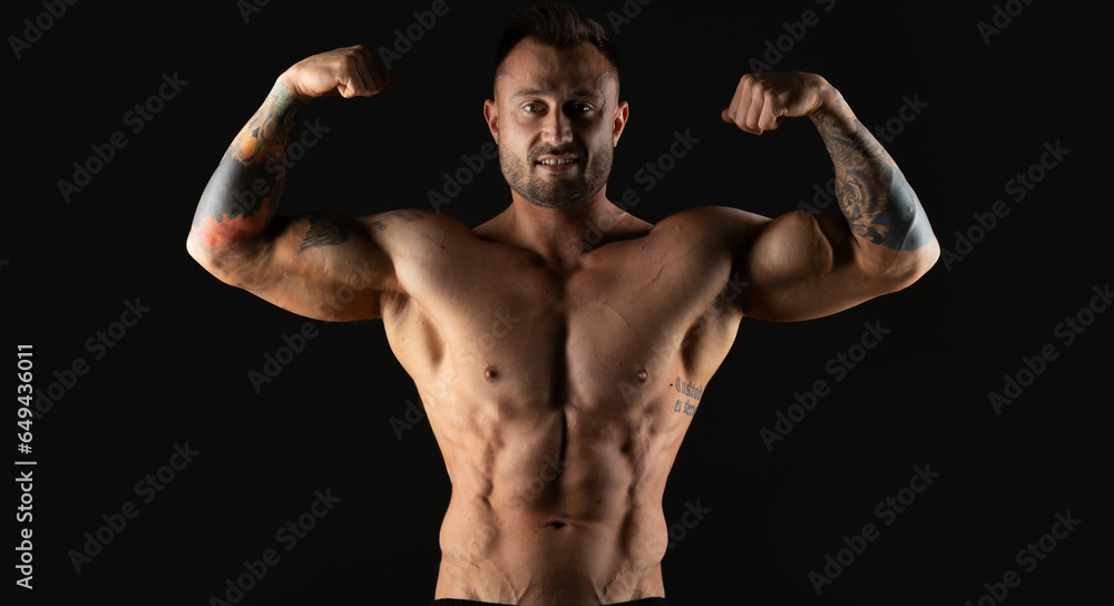 Bodybuilder, strong athletic man. Fitness model, muscular and torso with abs. Isolated on a black background with copy space. Bodybuilder, strong athletic man. Fitness model, muscular and torso with abs. Isolated on a black background with copy space.