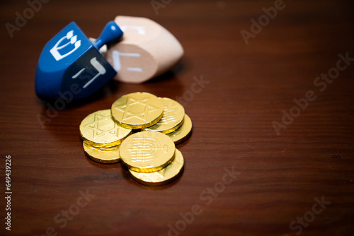 Pile of golden gelt and two dreidels for Hanukkah
