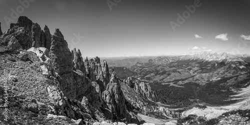 Black and white view of famous Dolomites mountain peaks. Sharp spiers of Latemar and in the background the Catinaccio and Sciliar massifs, South Tyrol, Italy. Awesome mountain panorama