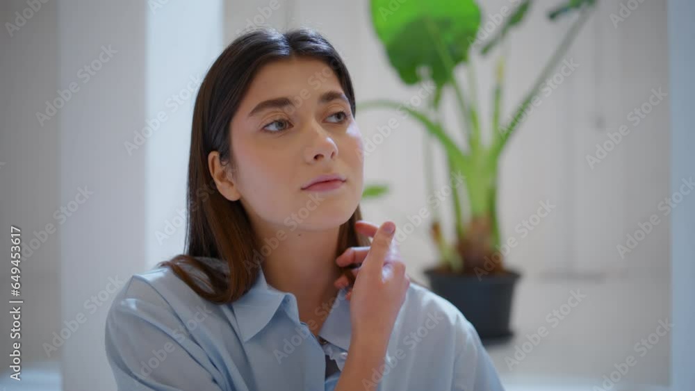 Brunette girl touching hair at home closeup. Beautiful serene woman look camera Brunette girl touching hair at home closeup. Beautiful serene woman look camera