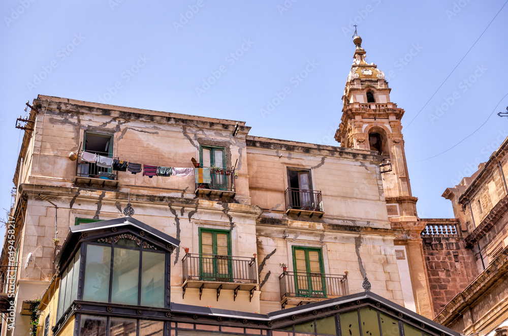 Fototapeta premium Palermo, Italy - July 18, 2022: Classic architecture and building facades on the streets in Palermo 