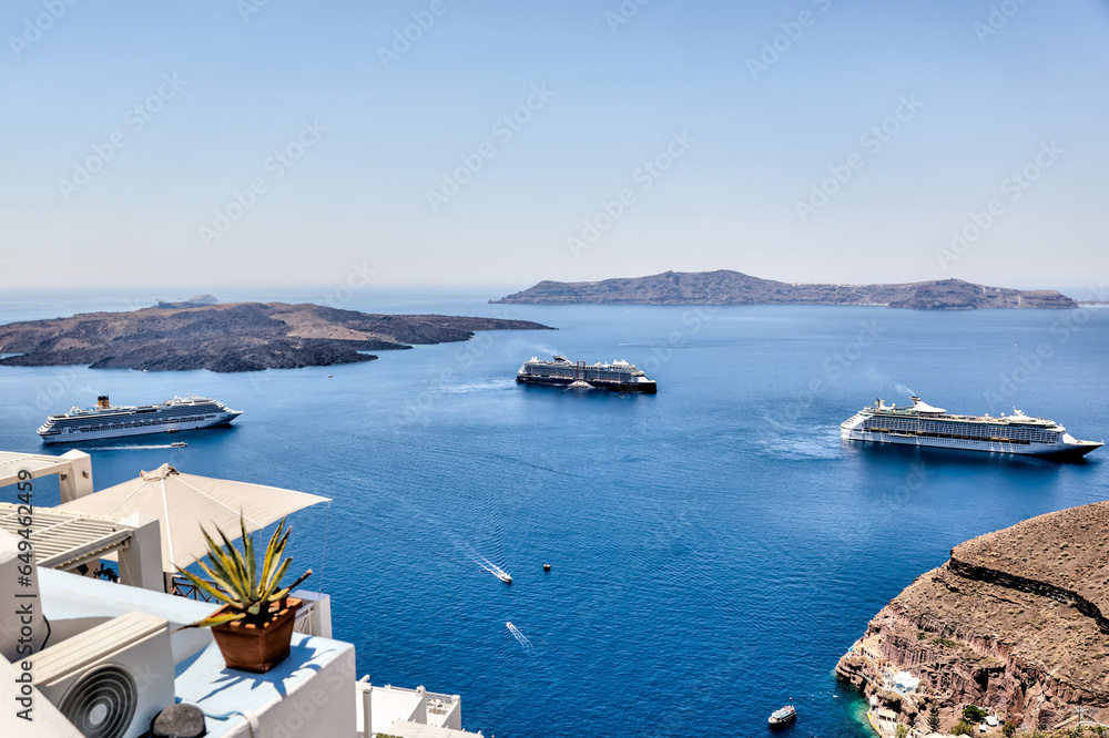 Fira, Greece - July 20, 2023: Views of cruise ships and the rocky landscapes from Fira on the island of Santorini in Greece
