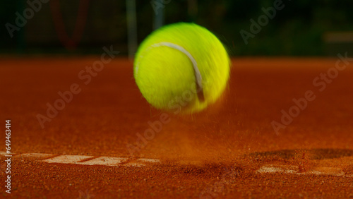 Bouncing tennis ball on clay court, freeze motion