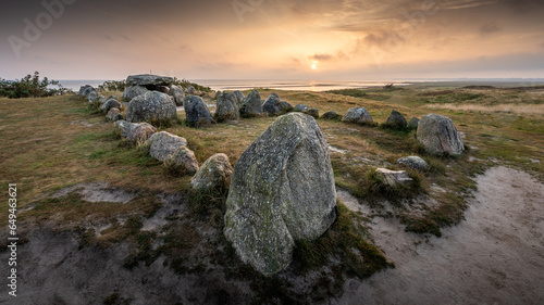 Goldener Sonnenaufgang hinter dem Hünengrab Harhoog im Osten der Insel Sylt im Herzen Nordfrieslands und der Nordsee photo