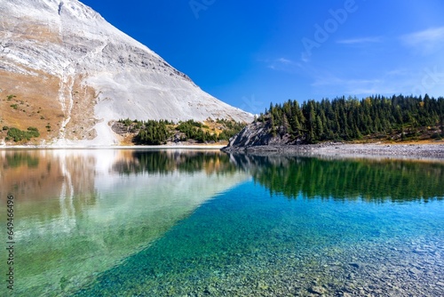 Mountain Peak Reflected in Crystal Clear Transparent Lake Water.  Scenic Kananaskis Country Landscape, Peter Lougheed Provincial Park, Alberta Canada photo